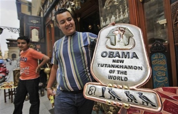 As Egypt prepares for the arrival of President Obama this week, a Cairo vendor displays a handmade copper plaque reading 'Obama, New Tutankhamun of the World.'